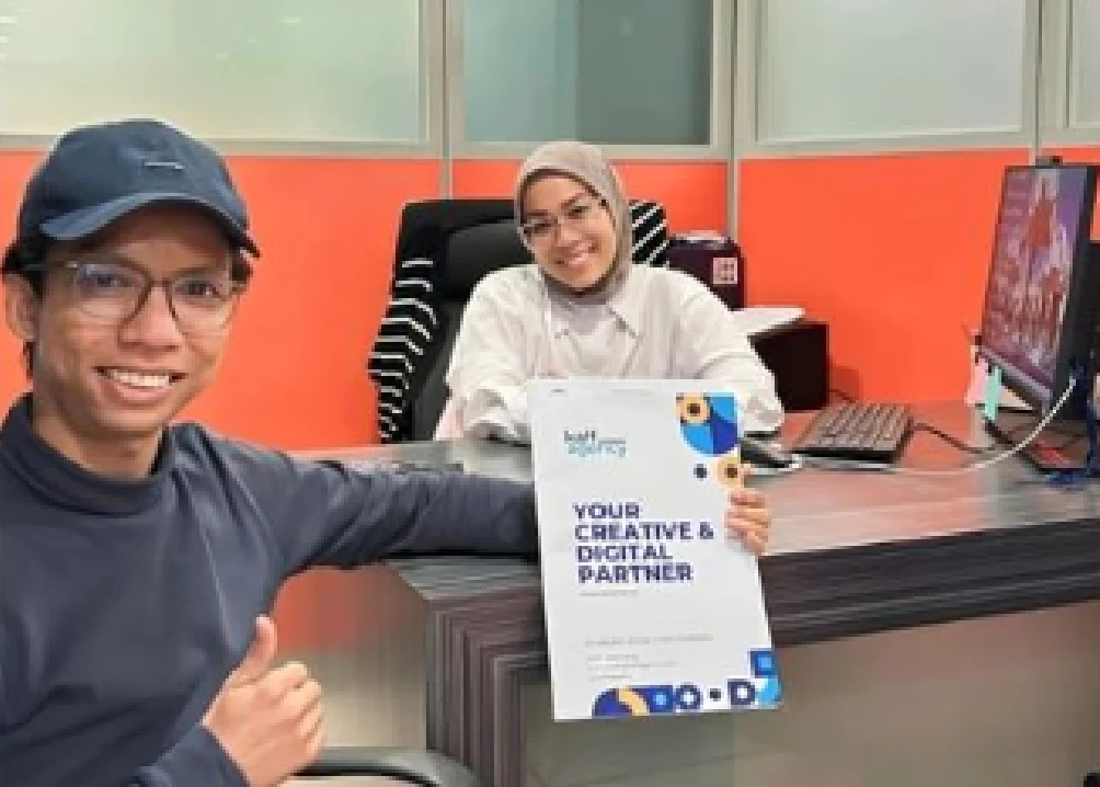 Kai with a client in an office