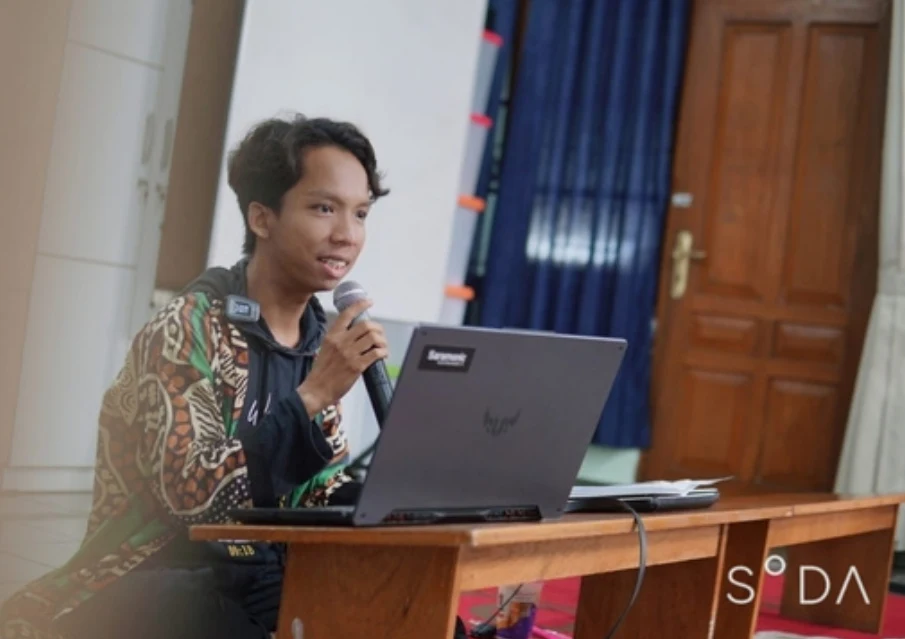Kai speaking at a community gathering