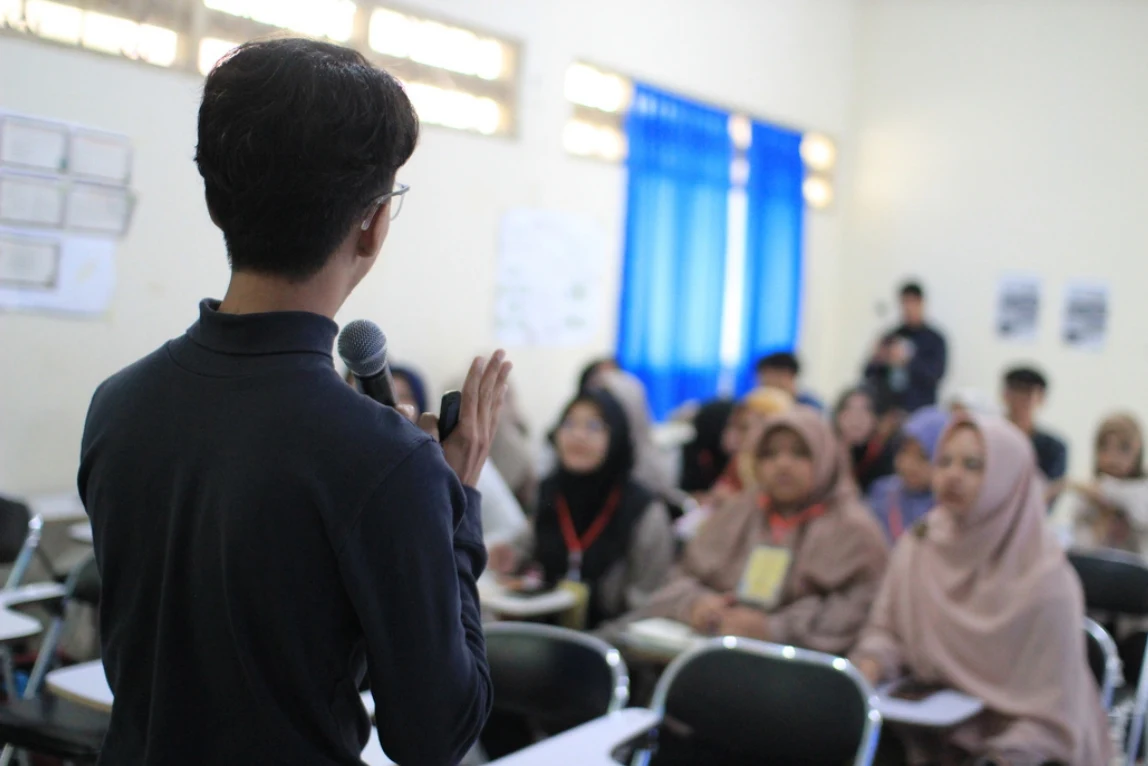 Kai speaking to a classroom audience